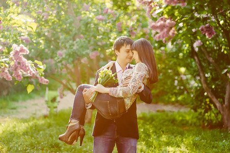 Young smiling happy couple in love in summer sunny evening  Toned imageの写真素材