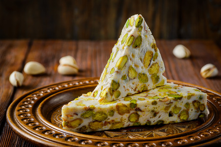 Turkish delight. Arabic dessert with and Pistachios on wooden plate. Selective focusの写真素材