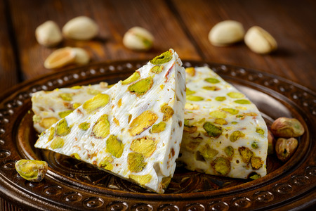 Turkish delight. Arabic dessert with and Pistachios on wooden plate. Selective focusの写真素材
