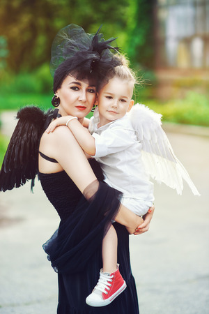 Mom with son playing good and evilの写真素材