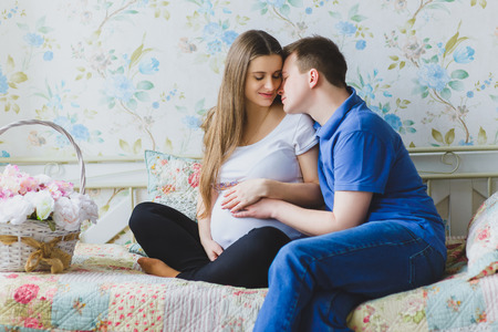 Happy pregnant couple hugging. Toned imageの写真素材