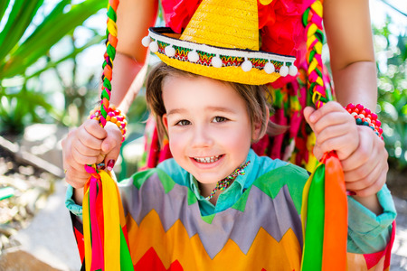 smiling little boy holding his mother braidsの写真素材