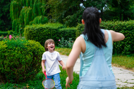 Mother and son playing badminton in the park.の写真素材