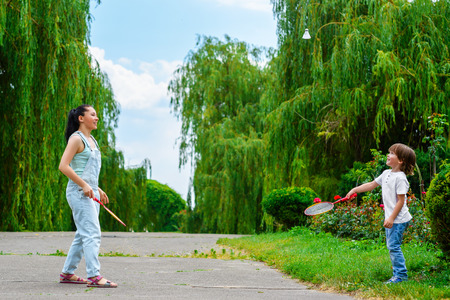 Mother and son playing badminton in the park.の写真素材