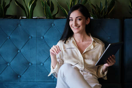 serious businesswoman working with tablet at city cafe