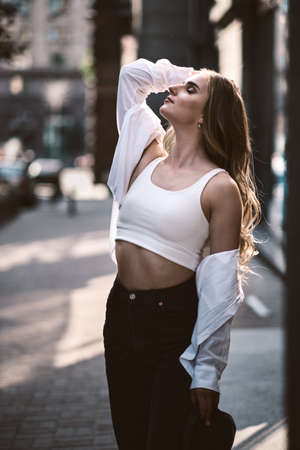 fashion portrait of young stylish beautiful woman in a urban backgroundの写真素材