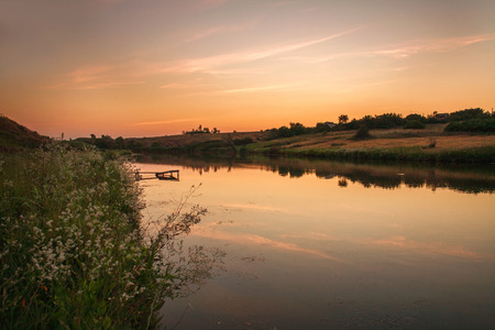 Rural landscape river in the sunset sky in retro style