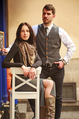 Young couple of actors in classic style clothing take part in scene of concept relationship on a town streetの写真素材