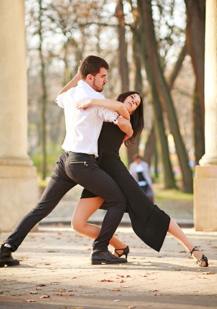 Passionate elegant young couple latino dancers in tango in the park, romantic and sporty lifestyleの写真素材