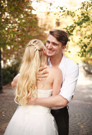 Joyful young couple of lovers dancing together on a wedding day in an autumn courtyardの写真素材