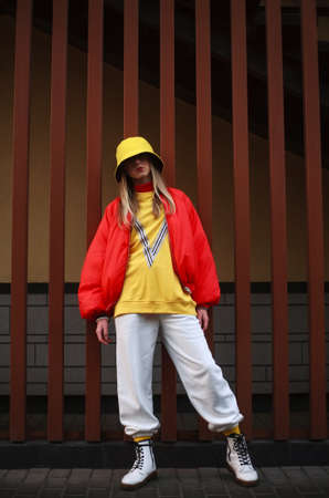 Teenager girl in colorful youth urban style clothing on the town streetの写真素材