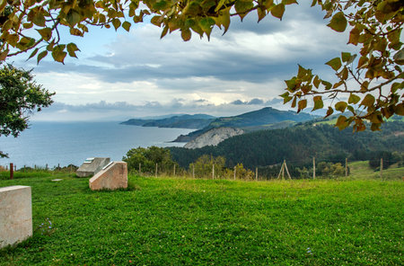 Landscape of rocky beach with hills, mountains and Atlantic Ocean coast of northern Spain, on the  sky backgroundの写真素材
