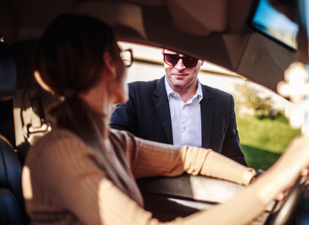 Corporate meeting of two employees in a car for work and discussion of businessの写真素材