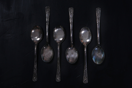 Melchior stolvye spoons on a black background. Table silverware on a black background.の写真素材