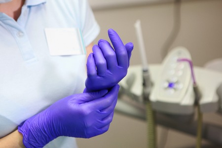 The hands of the doctor, who wear gloves. Macro photo. The concept of beauty and health. Photov doctor's officeの写真素材
