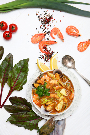 French seafood soup. Bouillabaisse ear of seafood. Food French sailors. White background, top view. Free space for inscriptions.の写真素材