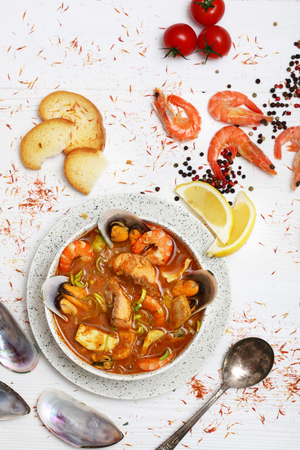 French seafood soup. Bouillabaisse ear of seafood. Food French sailors. White background, top view. Free space for inscriptions.の写真素材