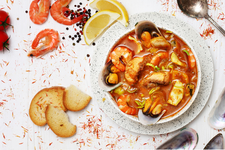 French seafood soup. Bouillabaisse ear of seafood. Food French sailors. White background, top view. Free space for inscriptions.の写真素材