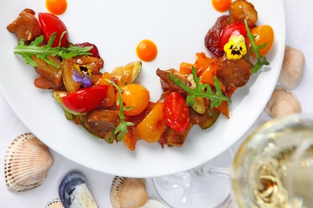 Salad from vegetables and rapanov meat. Meat shells rapanov from the Sea of Azov. Grilled vegetables with a great sauce. Blackberry top view.の写真素材