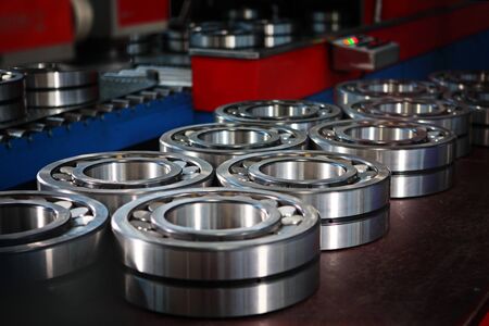 Finished products bearings in production after the conveyor. The glossy surface of steel products. Industrial industry concept.の写真素材