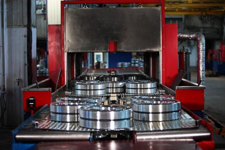 Oil-treated bearings move along the conveyor. Finished products. The glossy surface of steel products. Industrial industry concept.Photos at the factoryの写真素材
