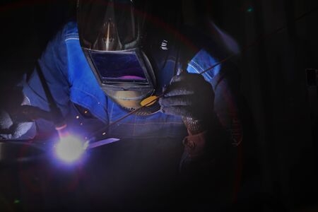 A worker by profession, a welder, closeups the details of a bearing in production. Photo without a...