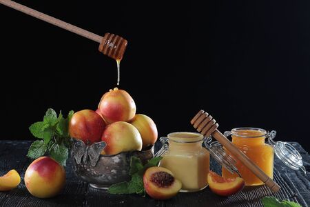 Drops of honey run down on apricots. Natural product. Copy space. Vintage tableware.の写真素材