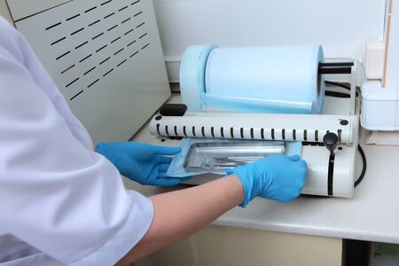Device for packaging dental devices for sterilization. Unrecognizable photo. Copy space.の写真素材