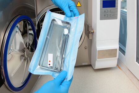 Dental instruments in a sealed bag with markers. Markers change color after sterilization. An unrecognizable photo without a face. Copy space.の写真素材