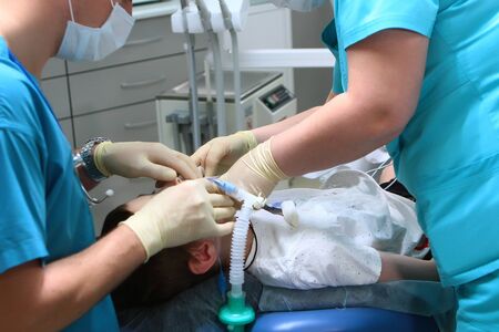 The work of an anesthesiologist and assistant before surgery. A little boy in the operating room. Concept of health care and life saving. Copy space.の写真素材