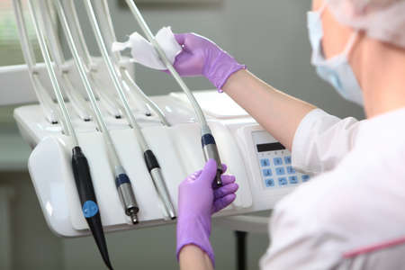A nurse wipes dental instruments. An unrecognizable photo.The concept of health. Copy space.Top...
