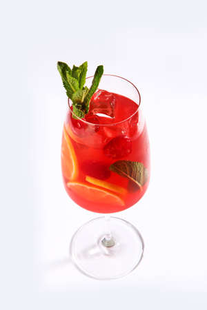 Lemonade made from oranges and mint. Soft drink in a tall glass on a white background. Copy of the...