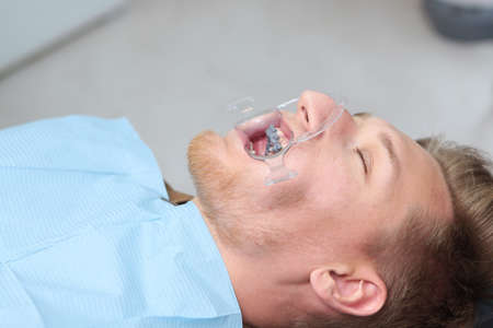 orrection of teeth and malocclusion in the dental clinic. Installation of braces. Mouth expander when installing braces. Macro photo. Top view. Copy space.の写真素材