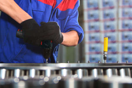 Assembly of bearings at the factory. Heavy industry. The large diameter bearing is out of focus. The...