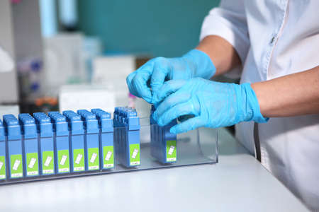 Tripod with many test tubes in the lab. Development of a new vaccine. A vaccine against Covid 19....