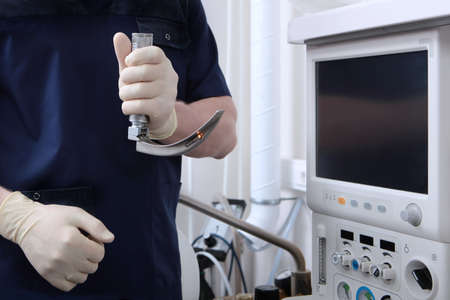 Laryngoscope in the hands of an anesthesiologist.Tracheal intubation. Preparation of equipment for surgery under general anesthesia.Airway patency.Ventilation of the lungs.An unrecognizable personの写真素材