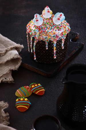 Easter cake in a festive package on a light background. Willow branches.Concept of the Easter...