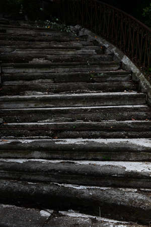 Old destroyed concrete staircase in the park. Close-up Signs of destruction. Vertical photo with grunge background.の写真素材
