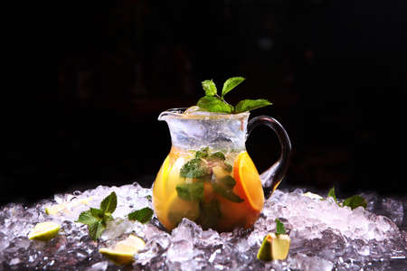 Homemade lemonade made from oranges, lemon and mint. Refreshing drink. Lemonade in glass jug. Copy space.の写真素材