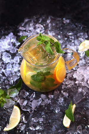 Homemade lemonade made from oranges, lemon and mint. Refreshing drink. Lemonade in glass jug.の写真素材