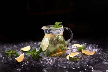 Homemade lime and mint lemonade. Refreshing drink. Lemonade in glass jug. Copy space.の写真素材