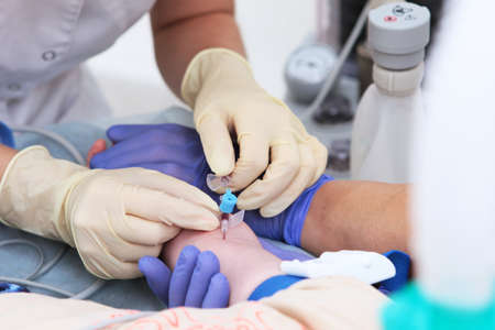 Intravenous injection. Preparing child for surgery under general anesthesia. Artificial lung ventilation apparatus.の写真素材