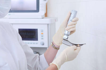 Apparatus for tracheal intubation in the hands of an anesthesiologist, resuscitator. Hands in protective gloves. Preparing for surgery. A device for artificial lung ventilation.Copy space.の写真素材