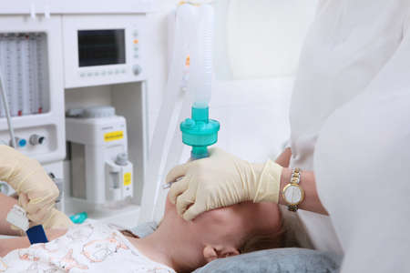 Intubation of the trachea. The child is connected to a ventilator. Preparing for surgery. General anesthesia for the child.の写真素材