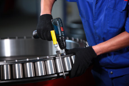 Worker assembles the bearing by hand. Bearing production. Bearing plant. Heavy industry. Beyond recognition.の写真素材