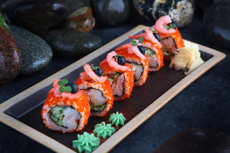 California rolls with shrimp. Traditional Japanese food. Rolls with shrimp, tobiko caviar and cucumber.Healthy food. Restaurant menu concept.Out of focus.の写真素材