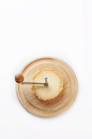 Elite Swiss cheese tete de moine. Special girolle knife for slicing cheese. Isolated object.Copy space.Vertical photo. Top view.の写真素材