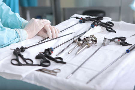 Medical instruments for laparoscopic surgery. Life saving. Gloved hands. Unrecognizable person