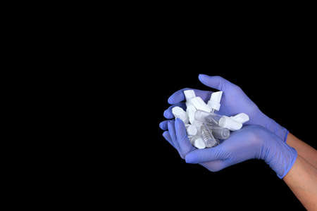 Empty containers for dental implants in the hands. Hands in gloves.The concept of installing dental implants. Modern dentistry.の写真素材