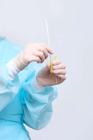A syringe in the hands of a nurse. Taking tests in a medical laboratory. Hands in protective gloves close-up.の写真素材